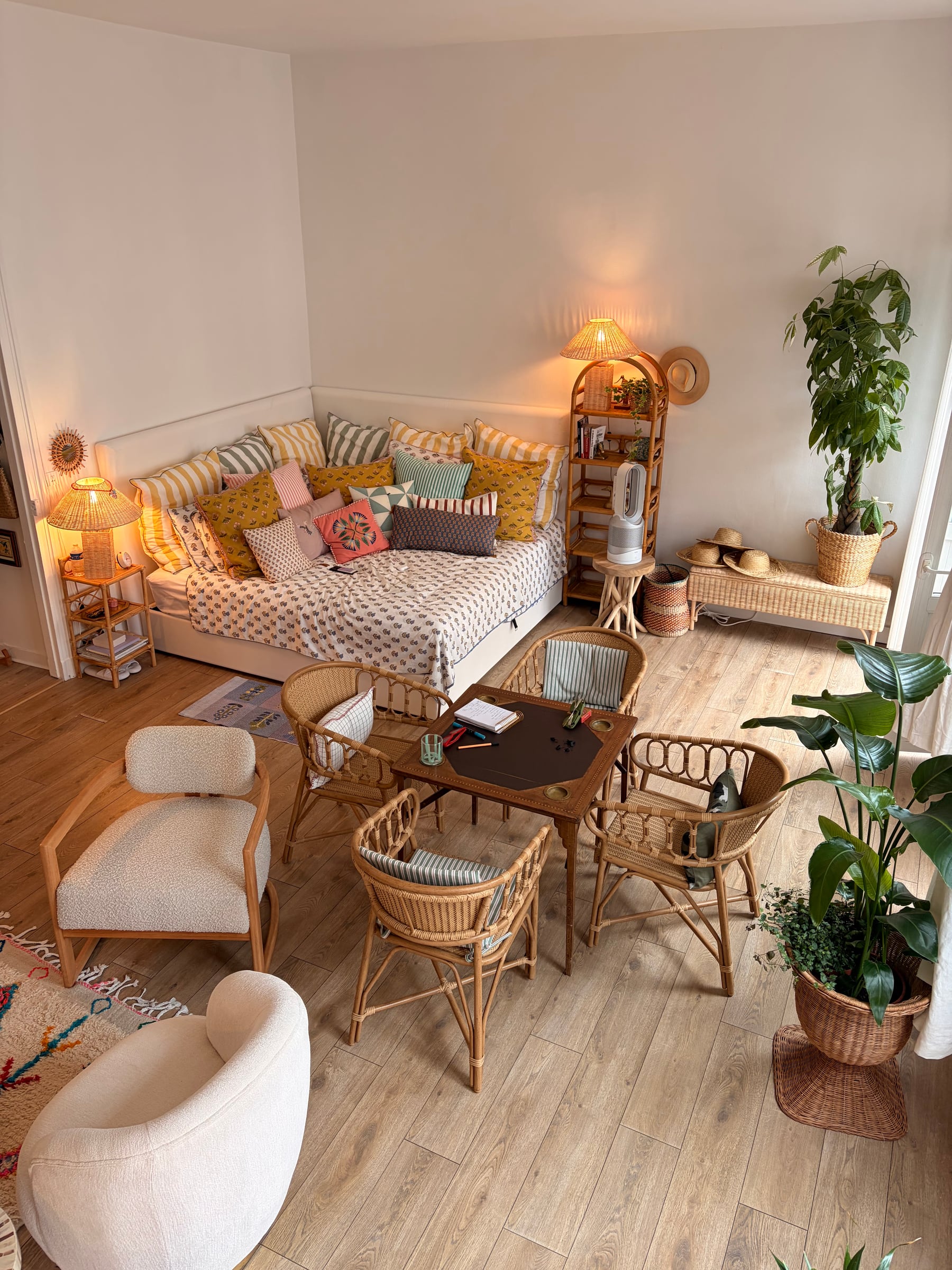 Day bed corner with a games table and rattan chairs