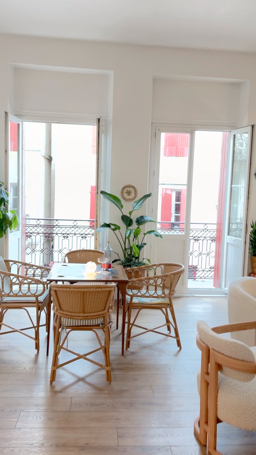 Rattan table and chairs by the balcony windows