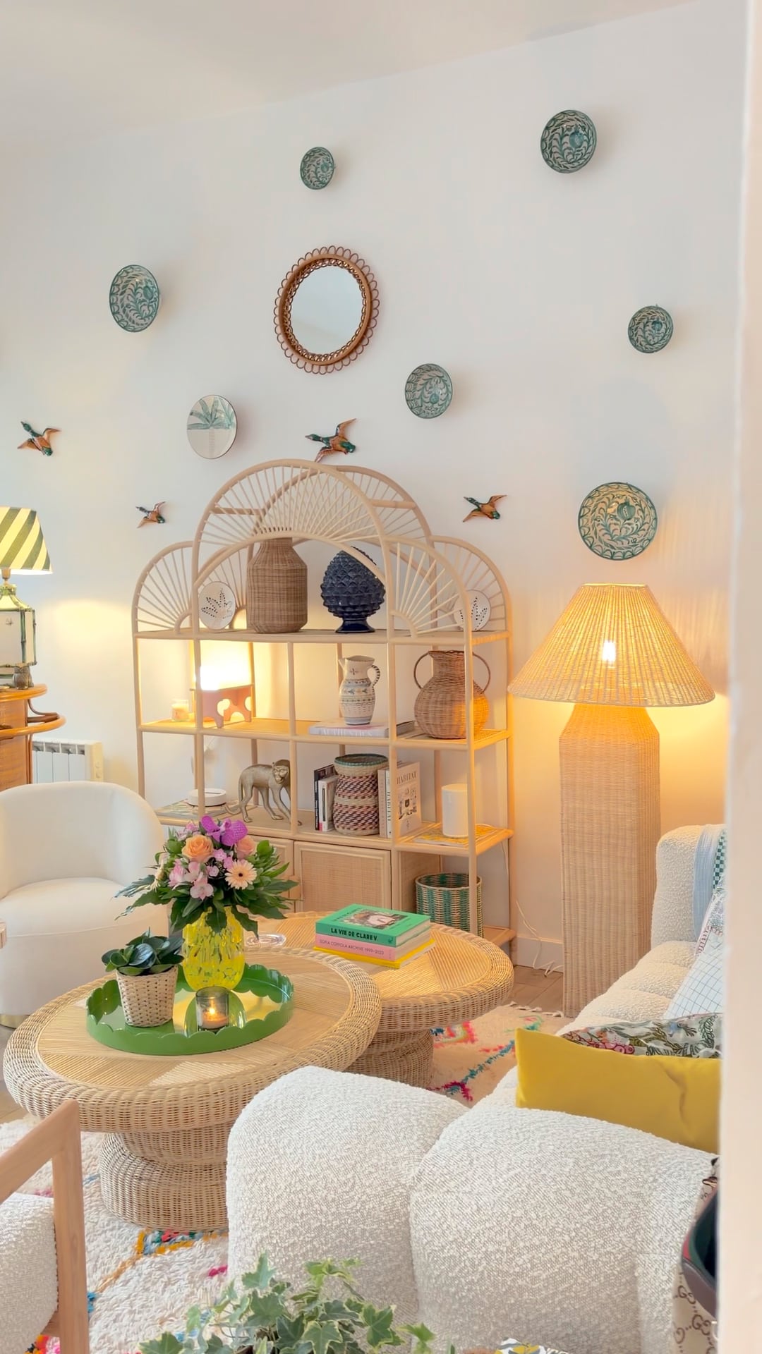 Wicker lamp glowing beside the rattan shelves and sofa