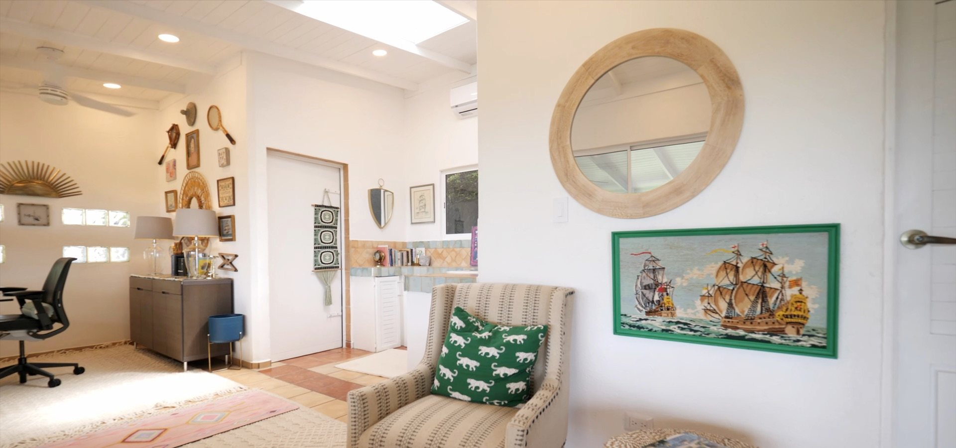 Sitting nook with a round mirror and chair