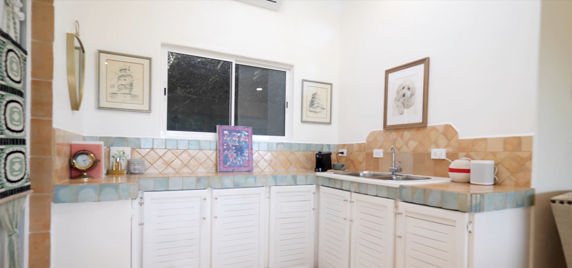 Kitchenette with tiled counters and open shelving