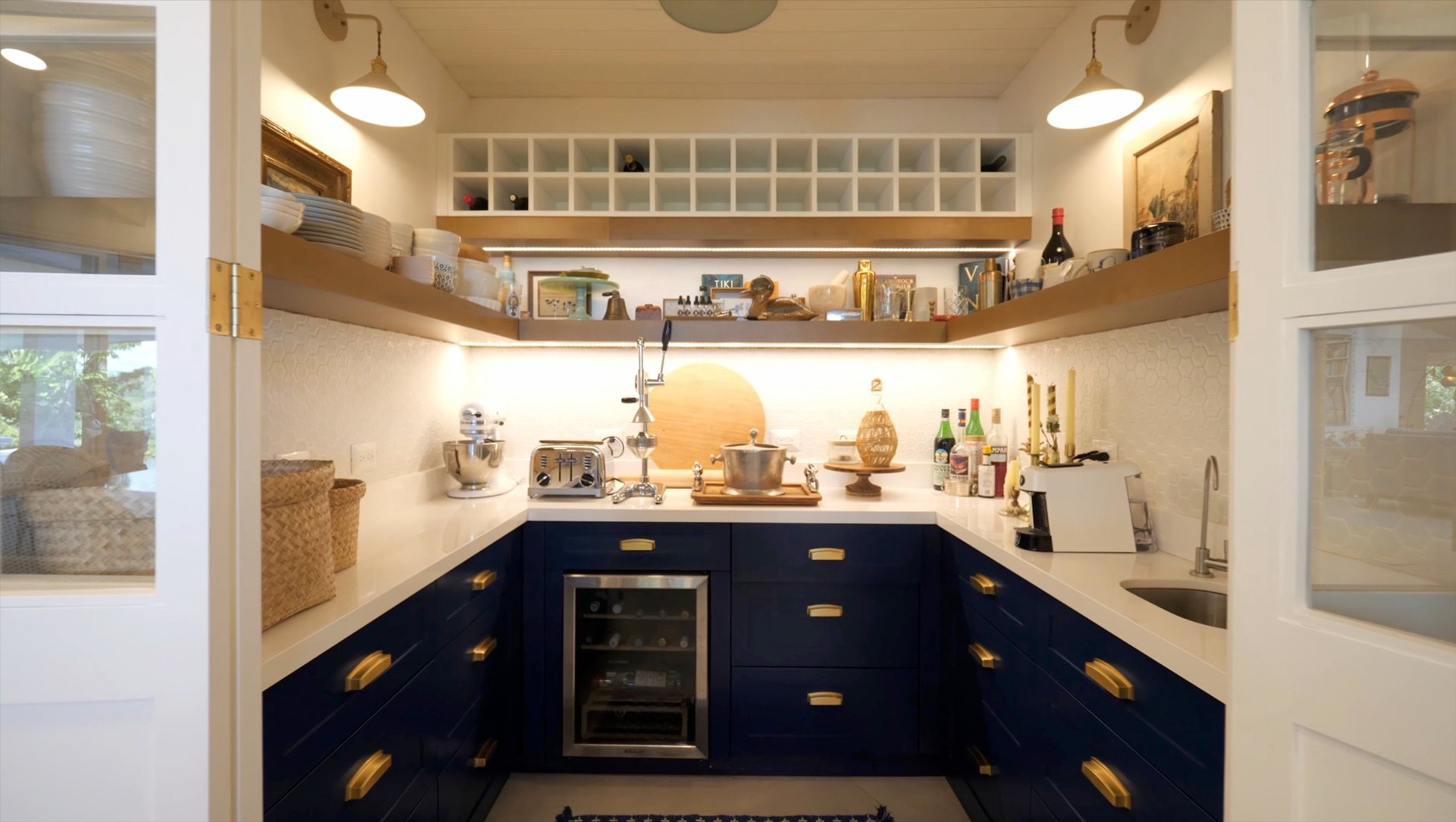 Navy butler's pantry with a wine fridge