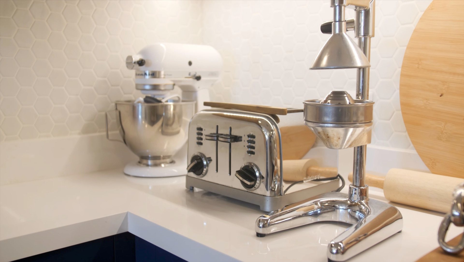 Mixer, toaster and juicer on the kitchen counter