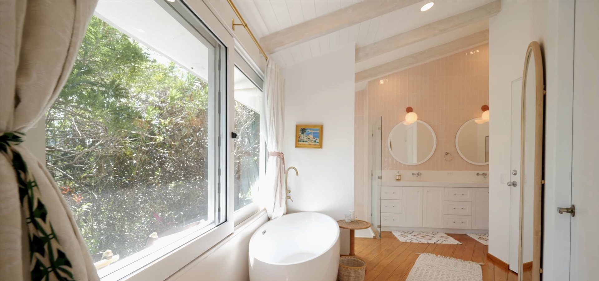 Freestanding tub beside the window