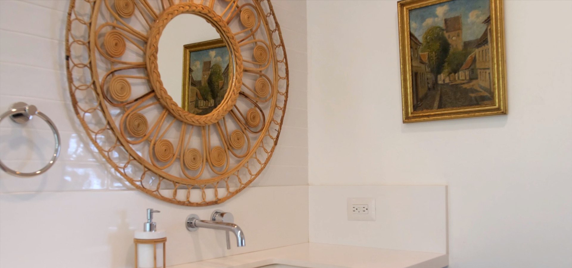 Vanity with a round rattan mirror