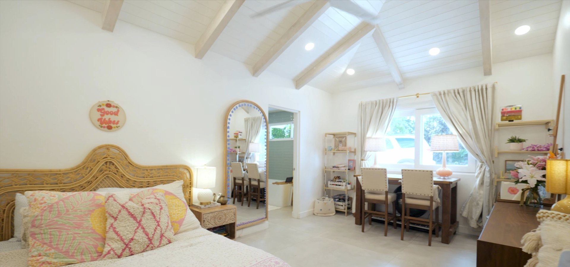 Bedroom with a mirror and desk by the window
