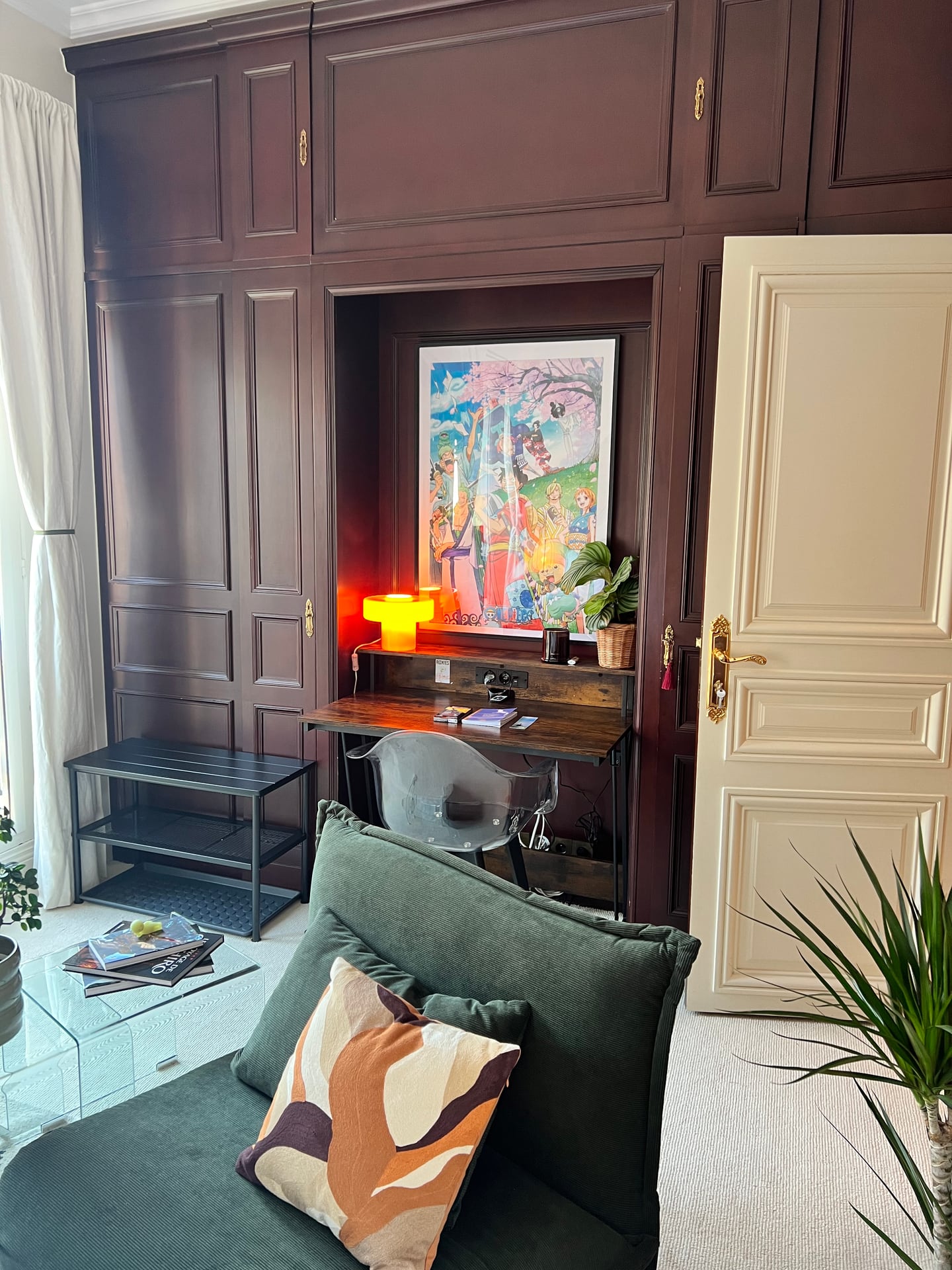Green sofa against dark wood panelling