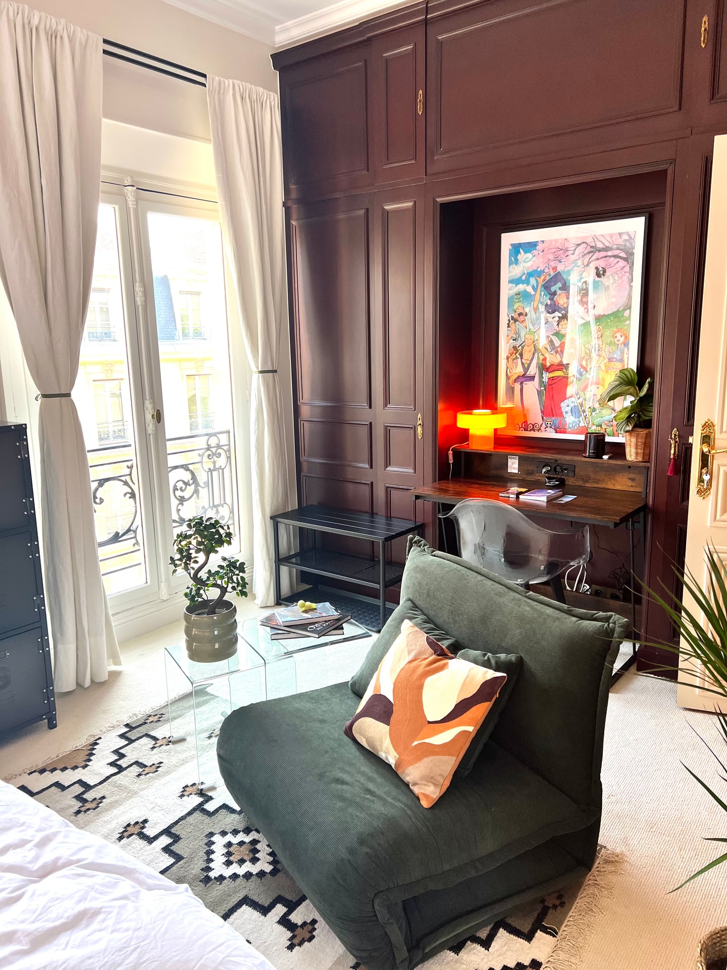 Wood-panelled corner with a desk and green chair