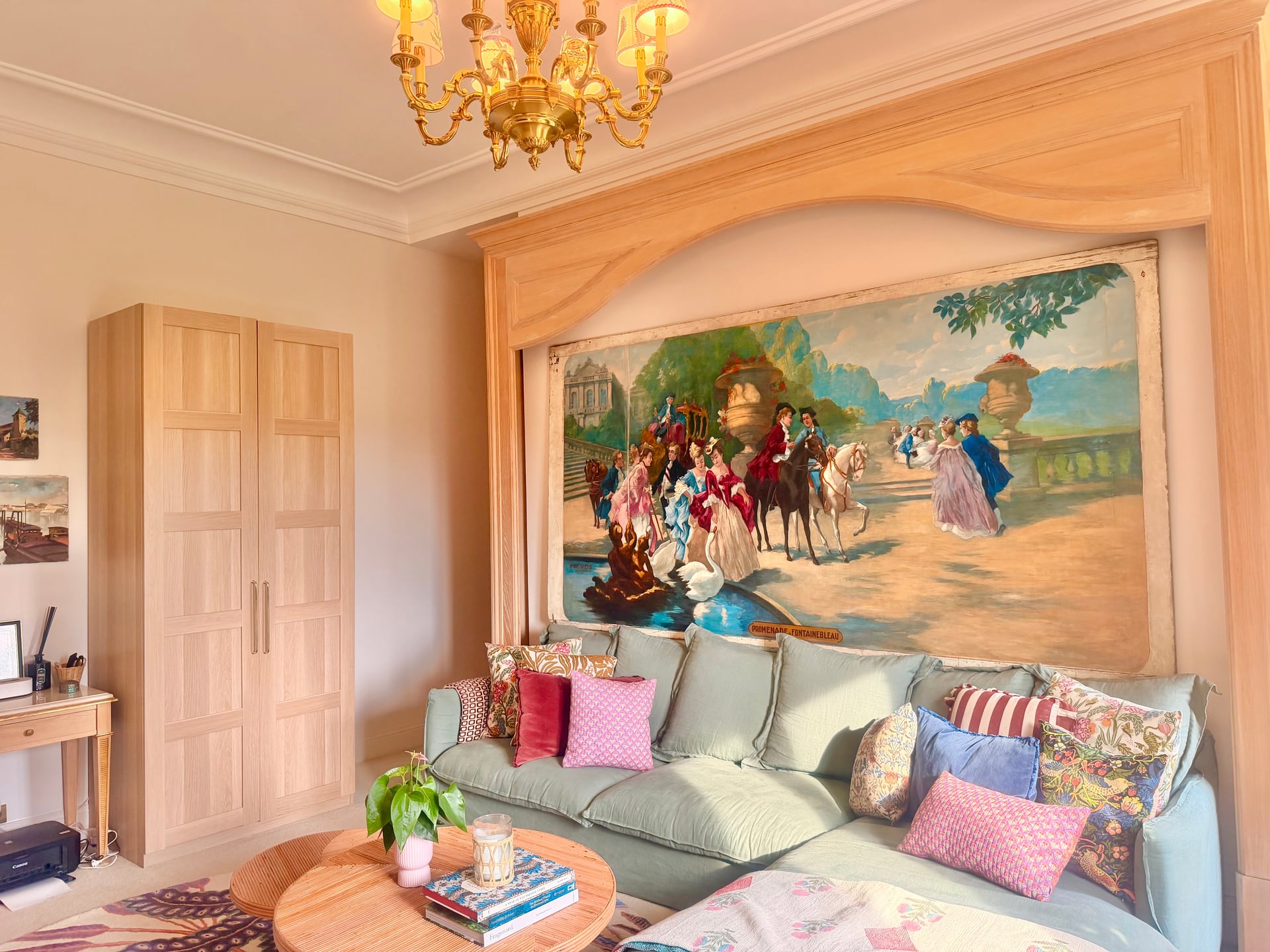 The green sofa under the riders mural