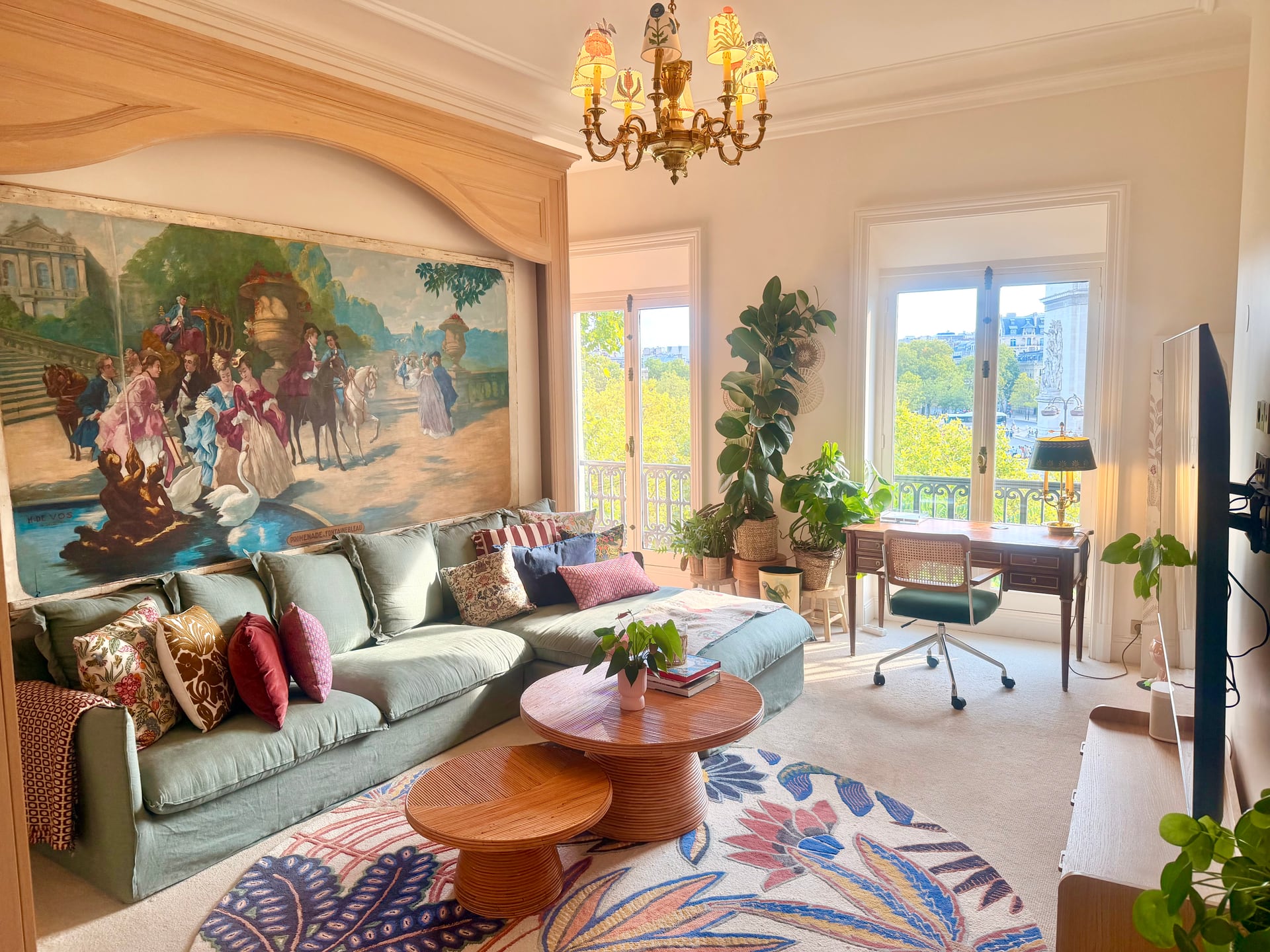 The Zen Den wide — green sofa, mural and desk in the window light